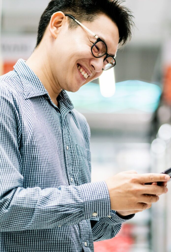 asian customer male shopping choose product from shelf in store mall background